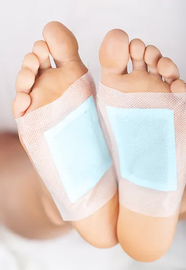 detox foot pads applied on pad of foot while sleeping